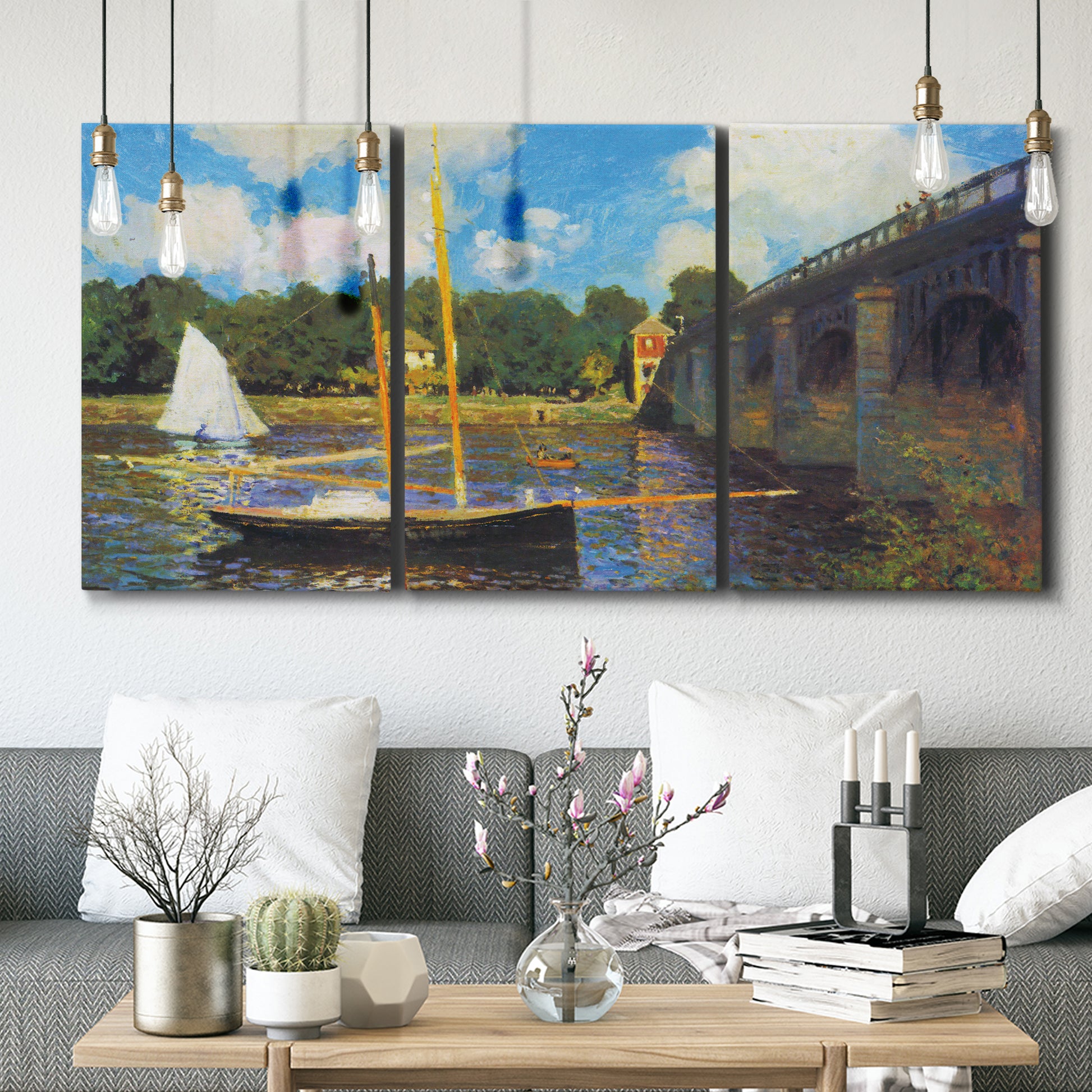 Three-panel canvas wall art featuring bridge crossing river landscape, displayed in a modern living room above seating.