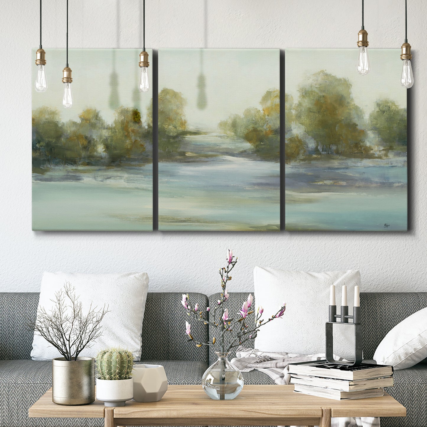 Three-panel canvas wall art featuring calming scenic landscape view, displayed in a modern living room above seating.
