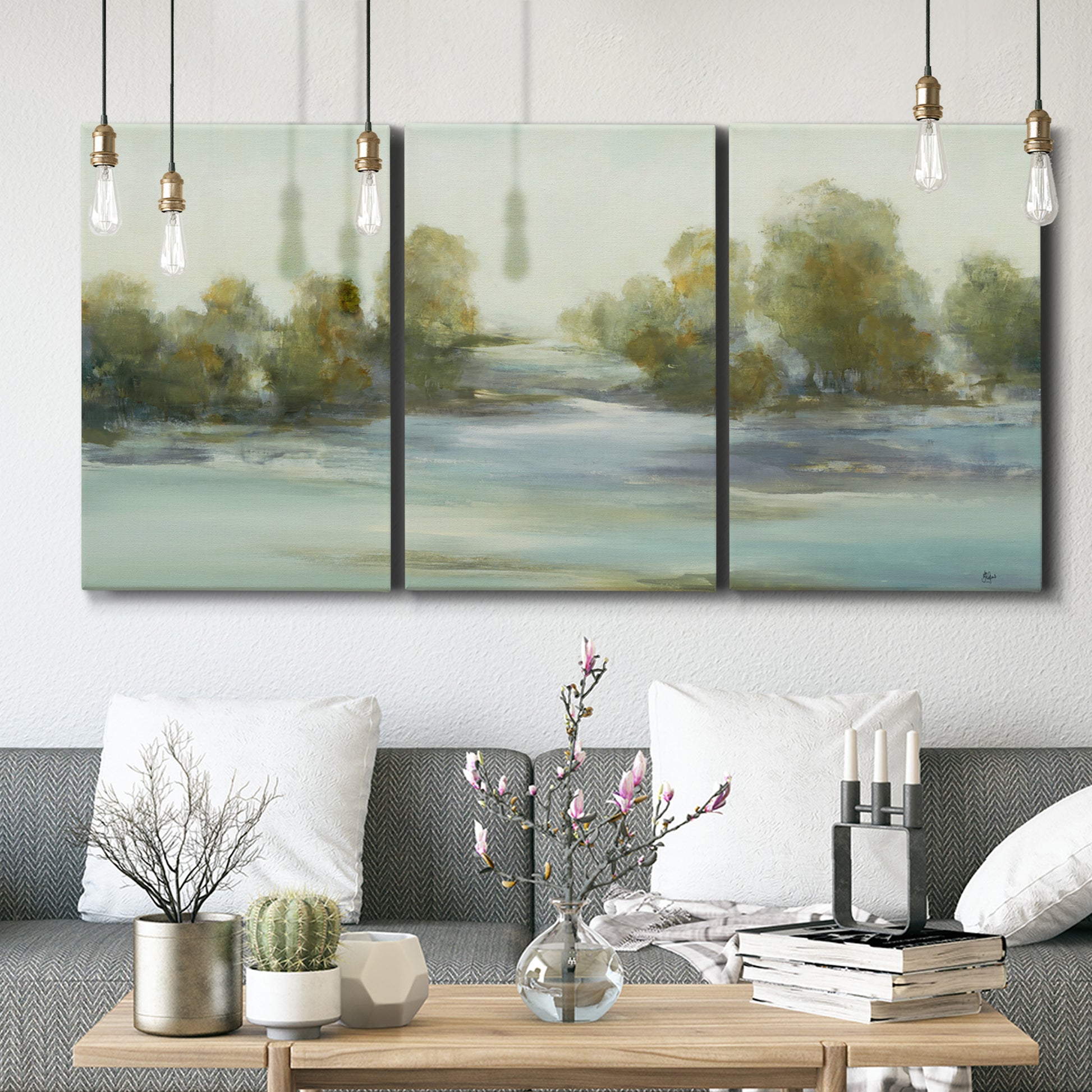 Three-panel canvas wall art featuring calming scenic landscape view, displayed in a modern living room above seating.