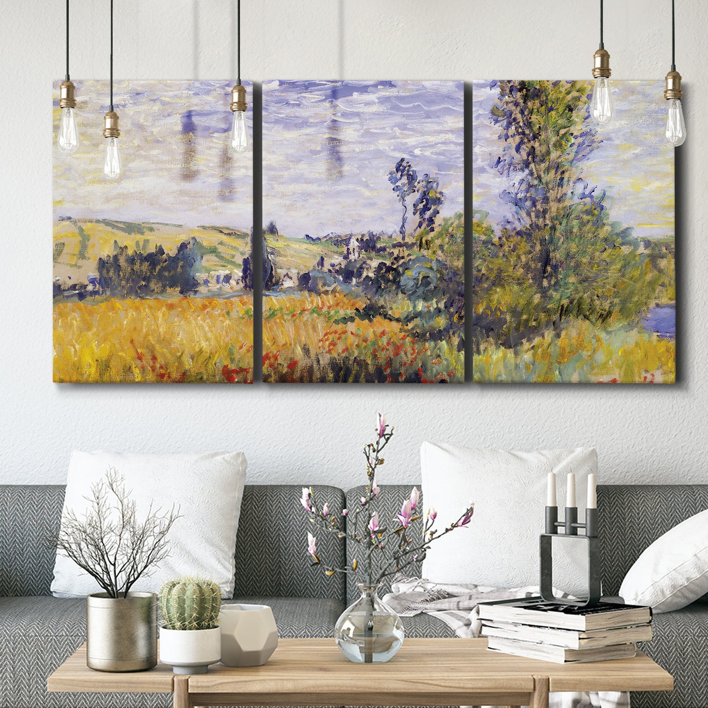 Three-panel canvas wall art featuring river village landscape with hills, displayed in a modern living room above seating.