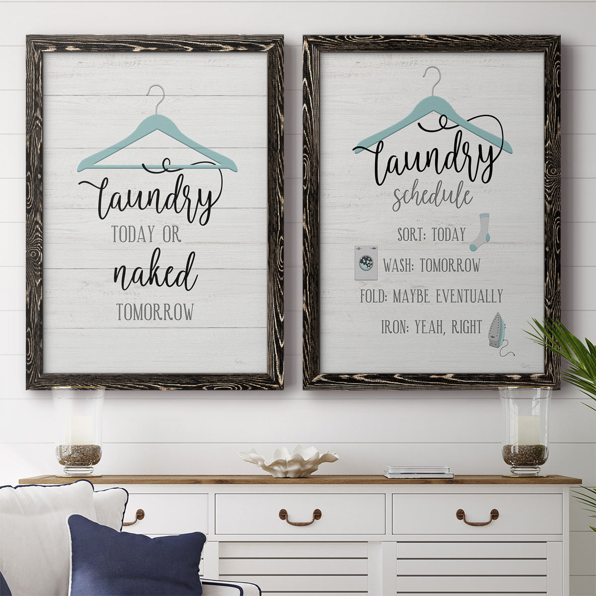 Set of two black barnwood framed canvas prints depicting a coordinated art pair of humorous laundry-room sayings and clothing icons rendered as rustic typographic wall art above a dining room sideboard.