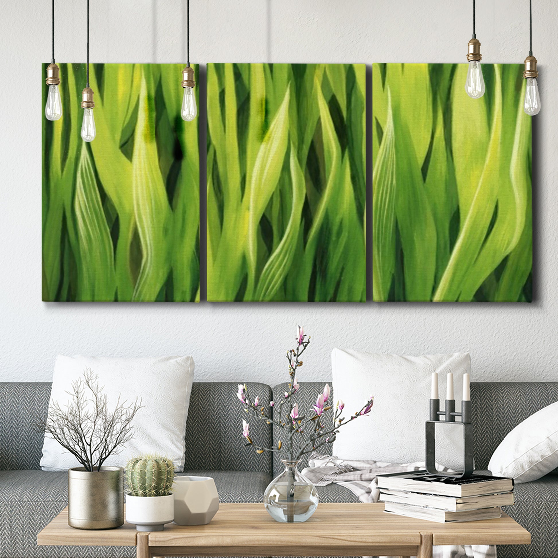 Three-panel canvas wall art featuring close view of tall green grass blades, displayed in a modern living room above seating.