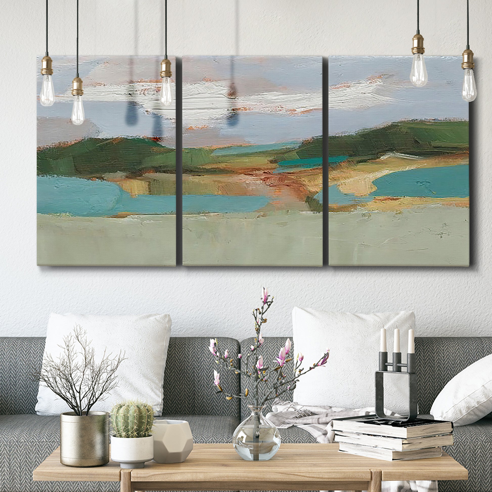 Three-panel canvas wall art featuring wide open landscape under midday light, displayed in a modern living room above seating.