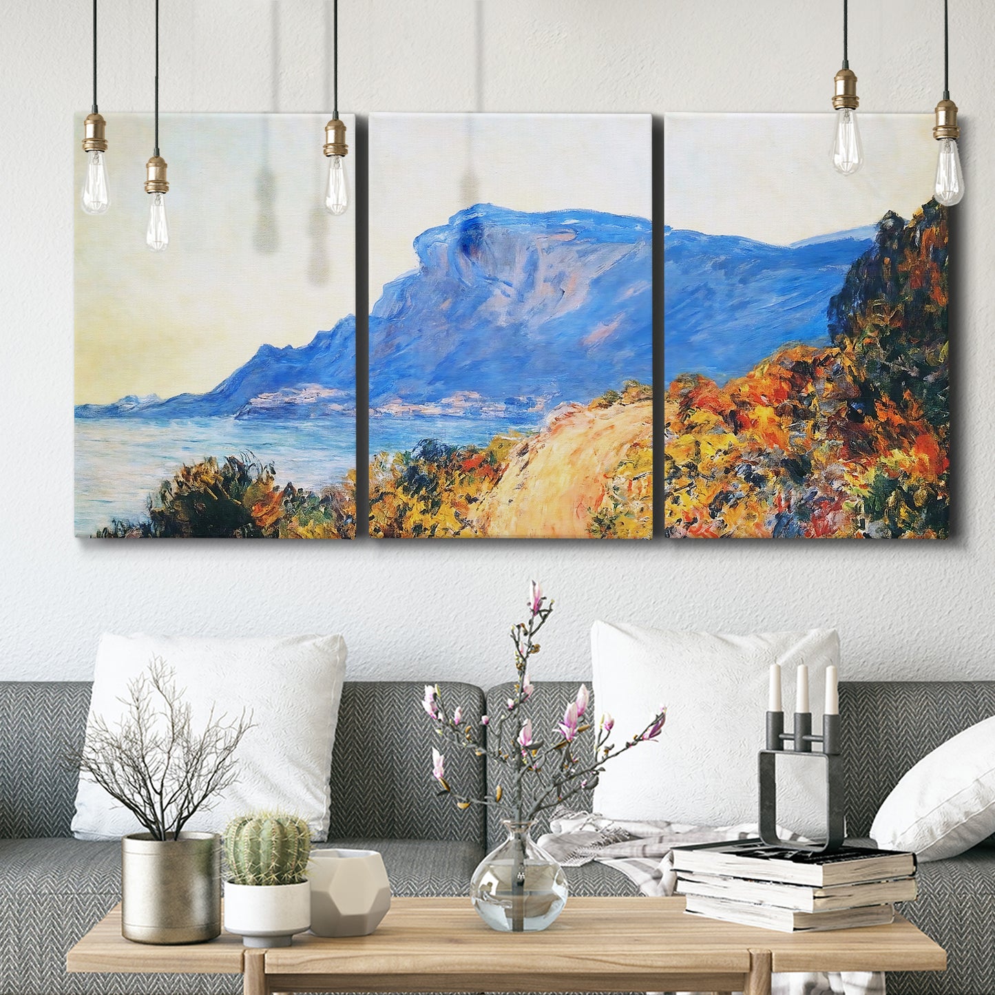 Three-panel canvas wall art featuring winding red road hillside, displayed in a modern living room above seating.
