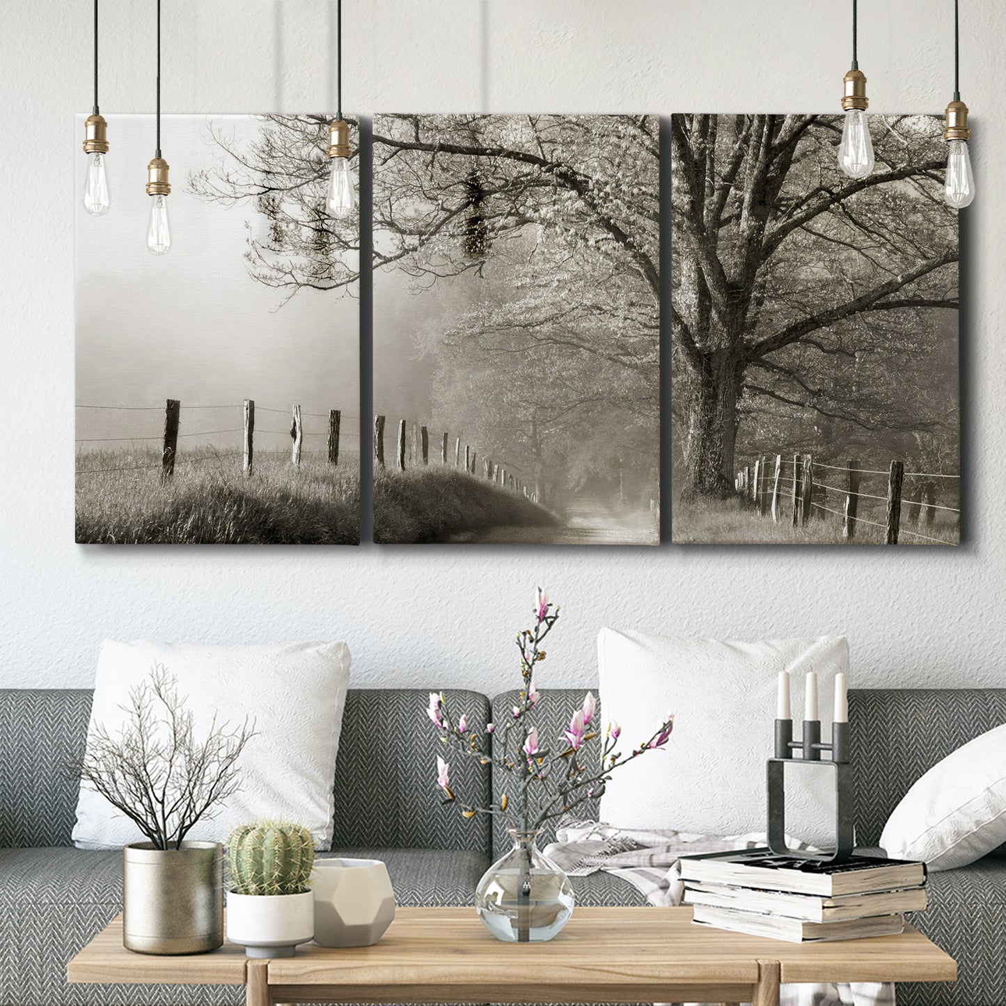 Three-panel canvas wall art featuring fenced rural path through countryside, displayed in a modern living room above seating.
