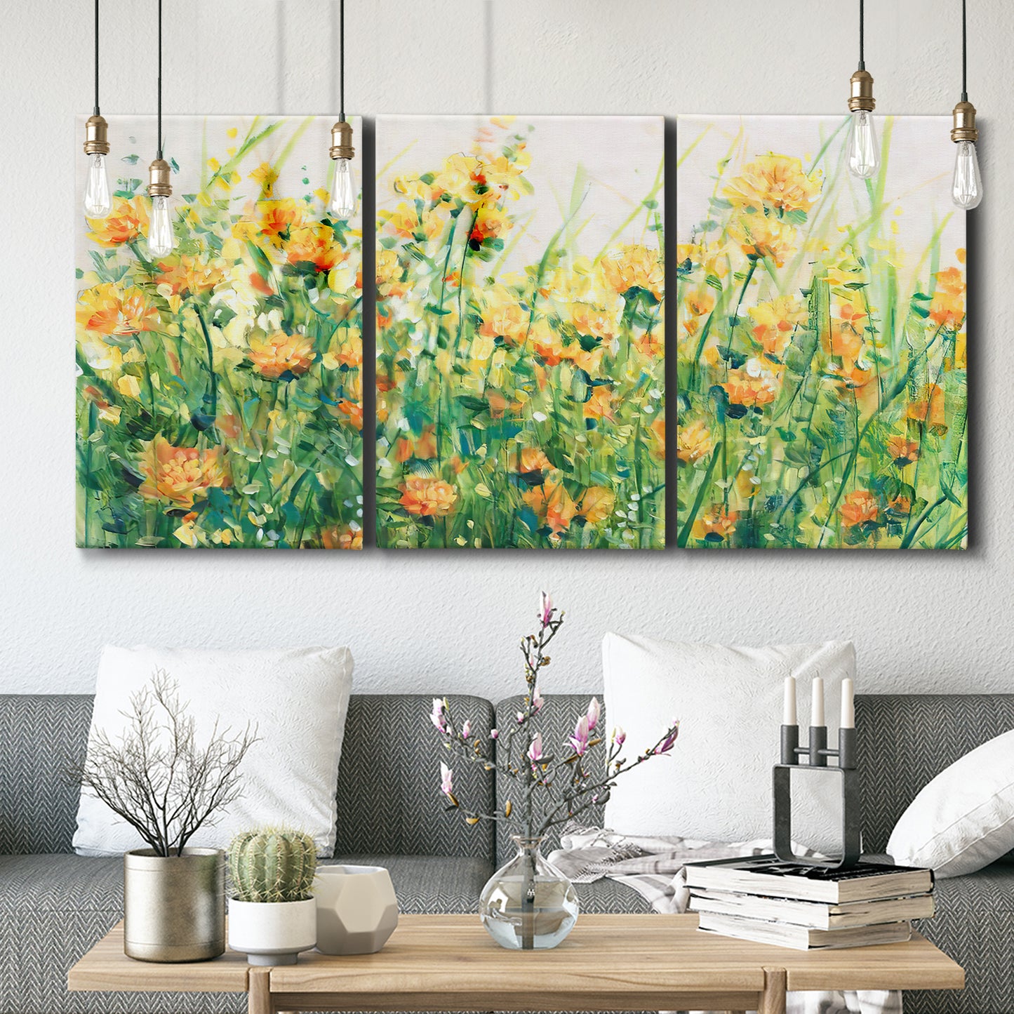 Three-panel canvas wall art featuring colorful garden flowers in bloom, displayed in a modern living room above seating.