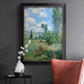 Impressionist pastoral landscape with poppy fields by Claude Monet in an ornate black frame with gilded inner detail displayed in a dark-toned interior setting.