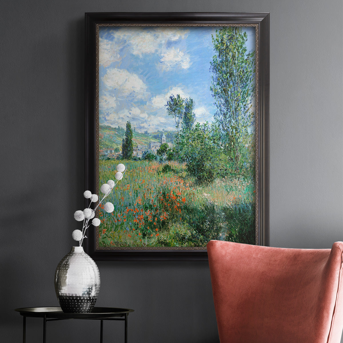 Impressionist pastoral landscape with poppy fields by Claude Monet in an ornate black frame with gilded inner detail displayed in a dark-toned interior setting.