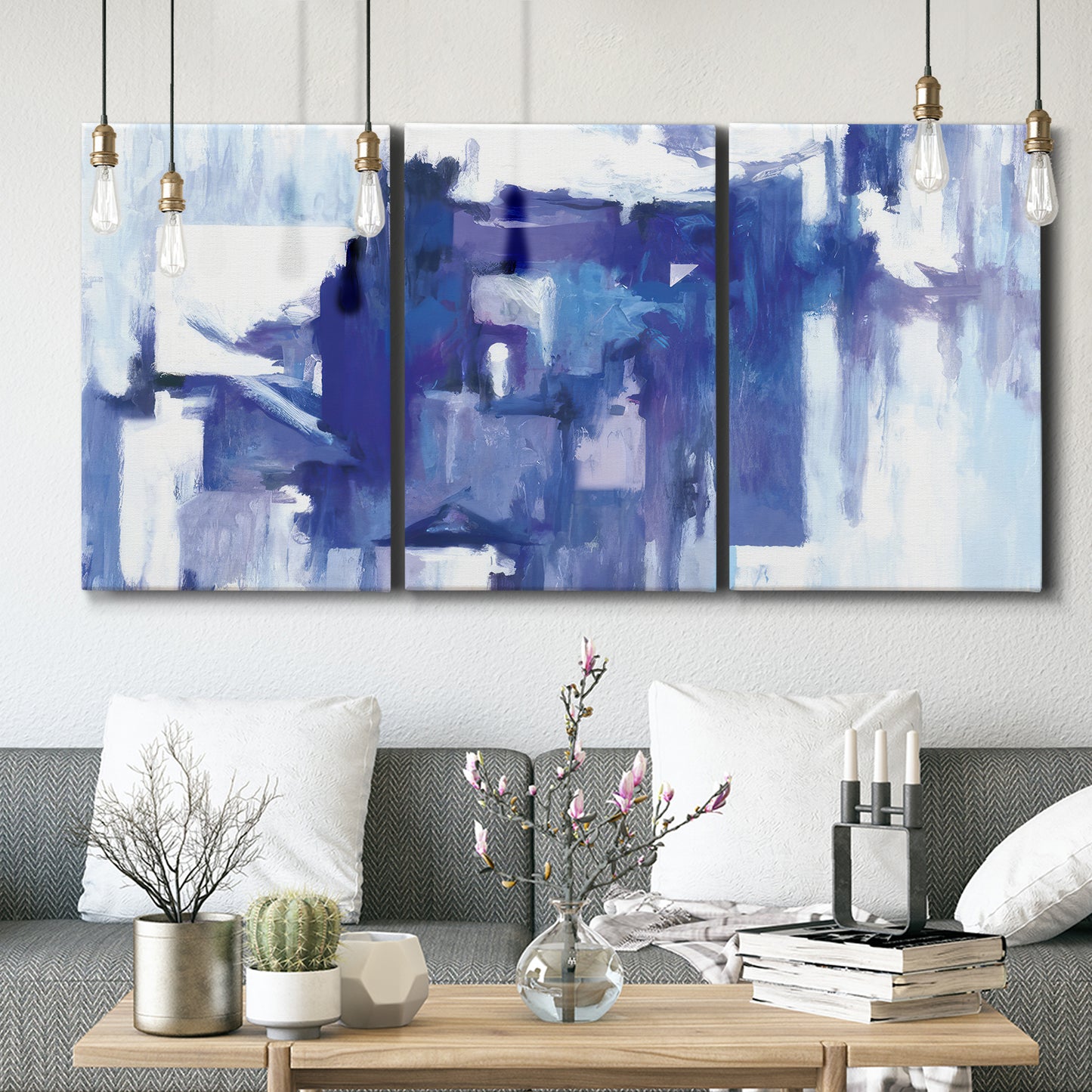 Three-panel canvas wall art featuring abstract urban street scene, displayed in a modern living room above seating.