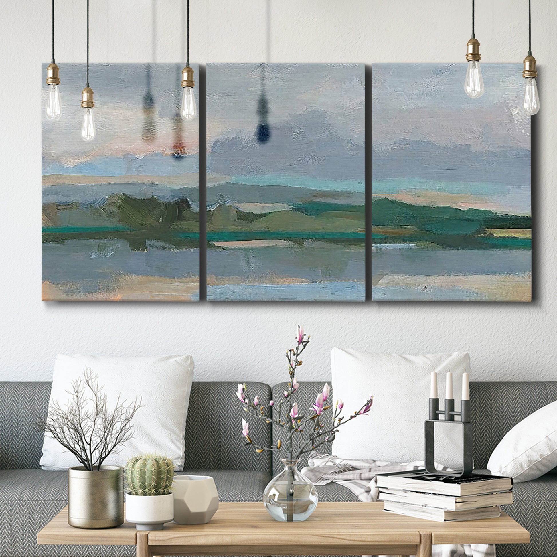 Three-panel canvas wall art featuring twilight landscape with fading light, displayed in a modern living room above seating.