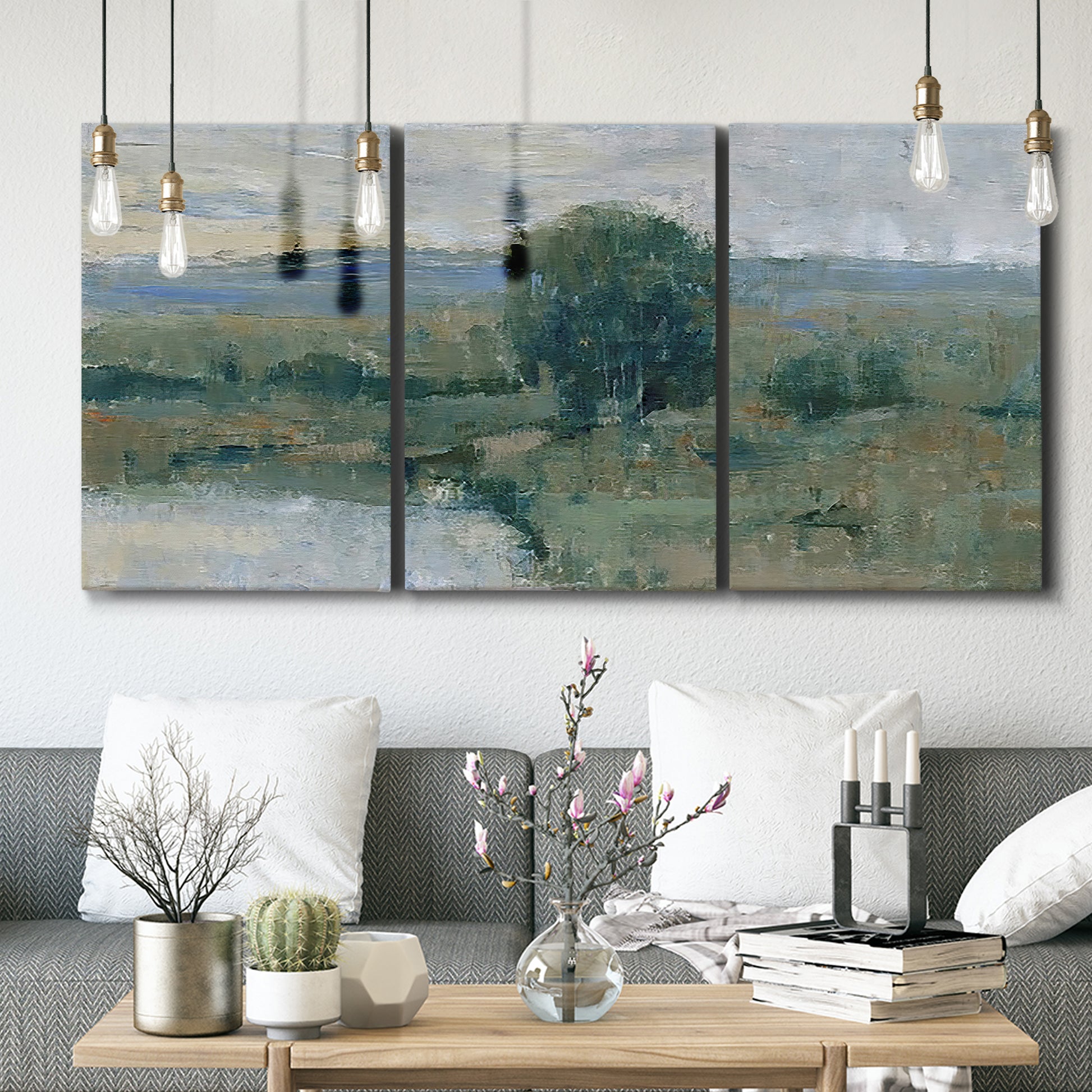 Three-panel canvas wall art featuring riverbank landscape with reflections, displayed in a modern living room above seating.
