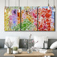 Three-panel canvas wall art featuring peaceful tropical inspired landscape, displayed in a modern living room above seating.