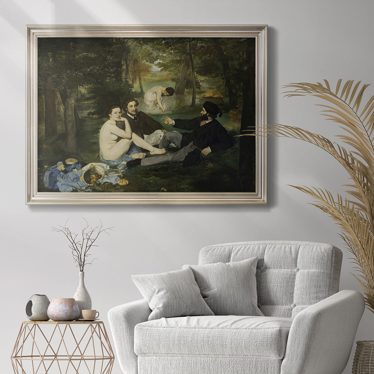 Groundbreaking impressionist picnic scene by Édouard Manet in an ornate champagne frame displayed in a bright interior setting.