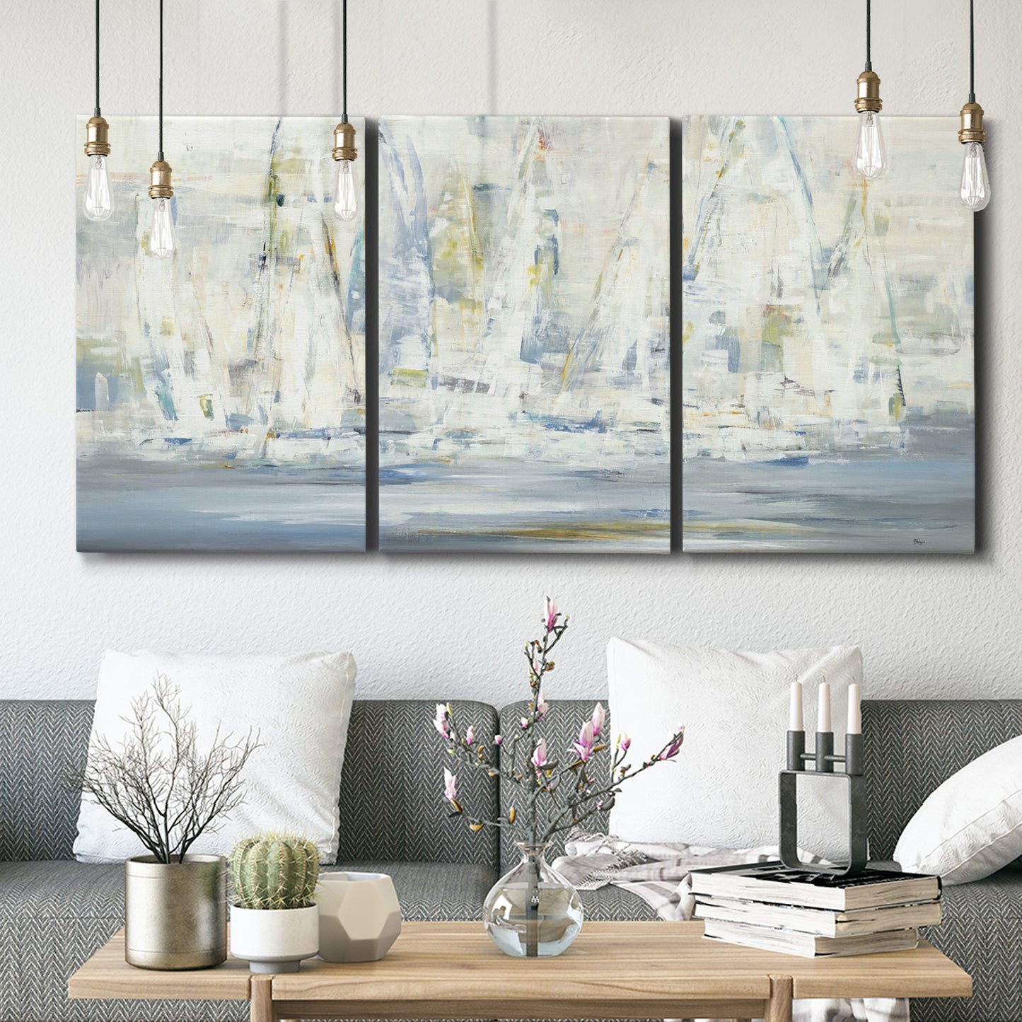 Three-panel canvas wall art featuring impressionist regatta scene with sailboats, displayed in a modern living room above seating.