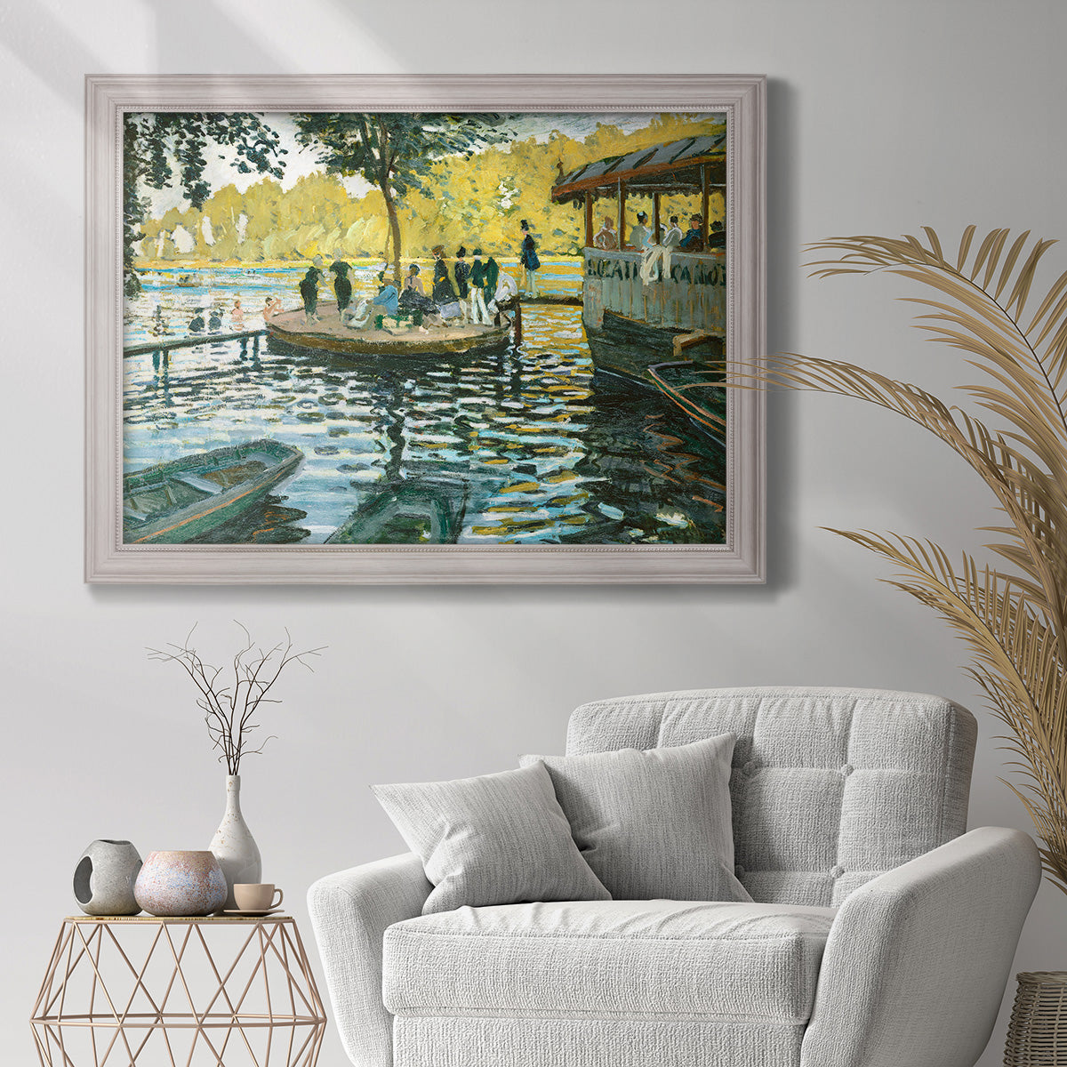 Impressionist riverside leisure scene by Claude Monet in an ornate weathered white frame displayed in a bright interior setting.