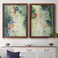 Set of two maple barnwood framed canvas prints depicting a coordinated art pair of layered blue green cream and charcoal textures rendered as nature-inspired mixed-media abstracts above a dining room sideboard.