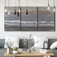 Three-panel canvas wall art featuring shoreline between land and sea, displayed in a modern living room above seating.