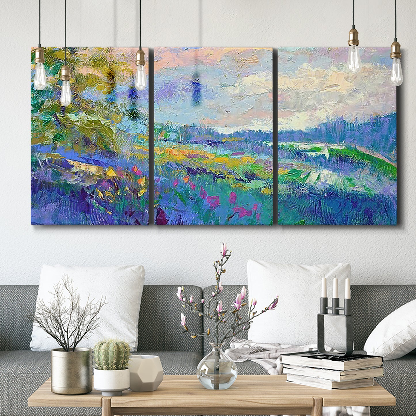 Three-panel canvas wall art featuring cheerful landscape under open sky, displayed in a modern living room above seating.