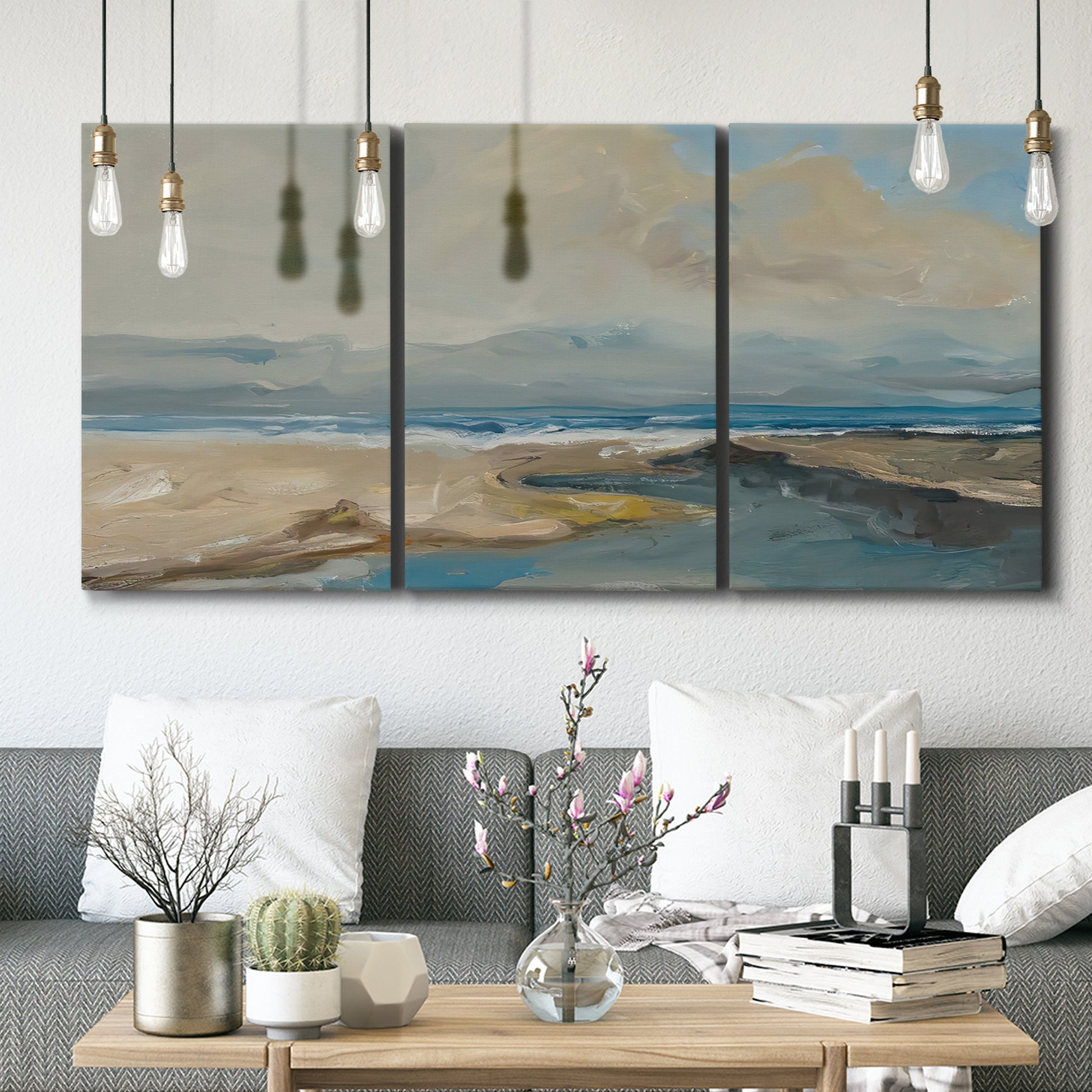 Three-panel canvas wall art featuring abstract coastal landscape, displayed in a modern living room above seating.