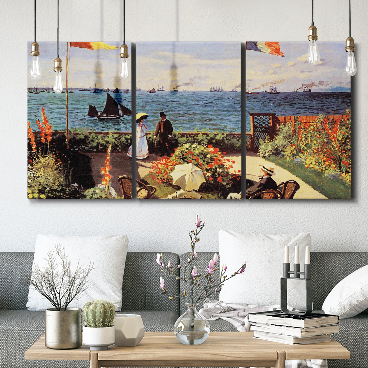 Three-panel canvas wall art featuring coastal garden overlooking sea, displayed in a modern living room above seating.