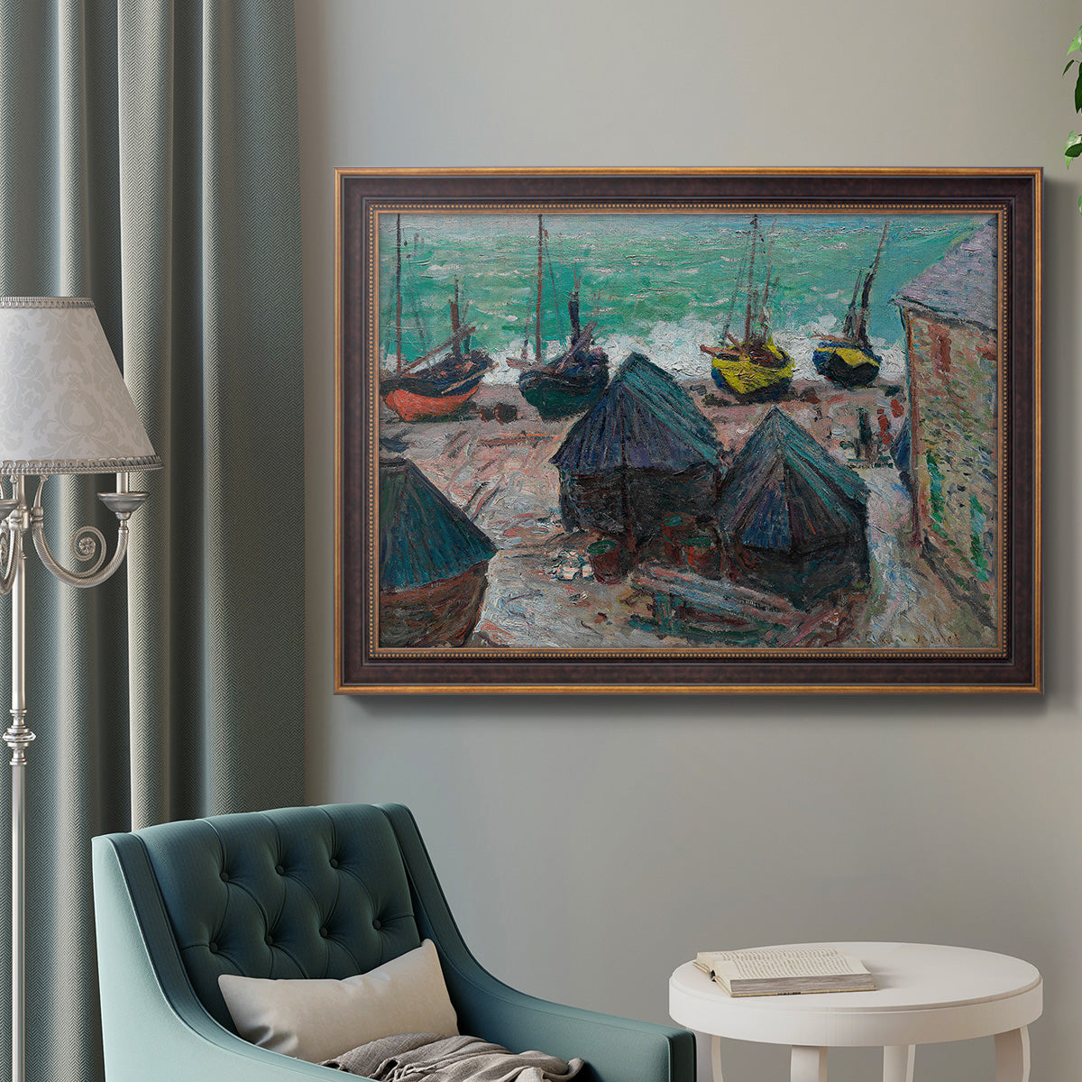 Impressionist coastal beach scene with boats by Claude Monet in an ornate bronzed mahogany wood frame displayed in a bright interior setting.