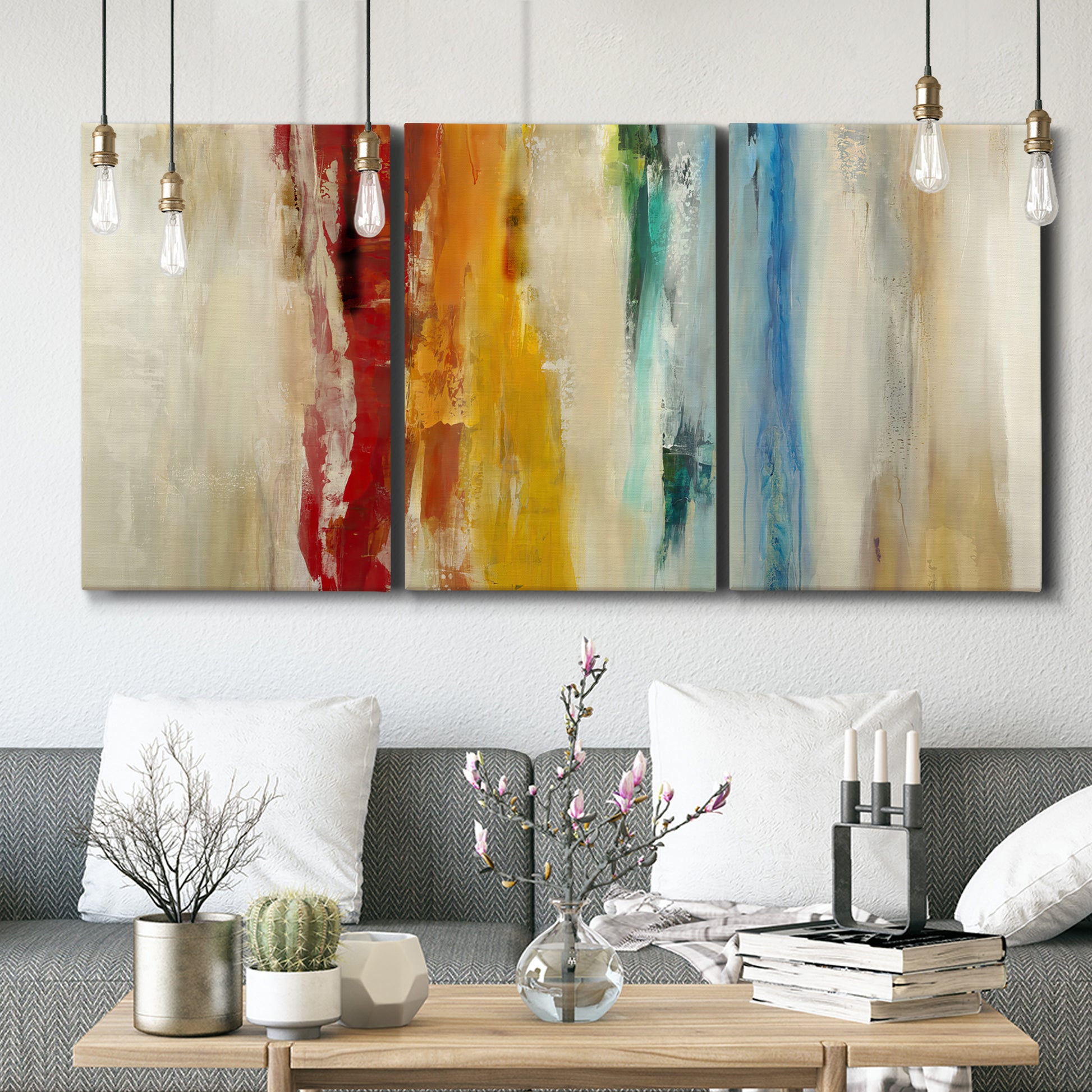 Three-panel canvas wall art featuring abstract divided color hemisphere forms, displayed in a modern living room above seating.