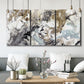 Three-panel canvas wall art featuring marbled modern abstract textures, displayed in a modern living room above seating.