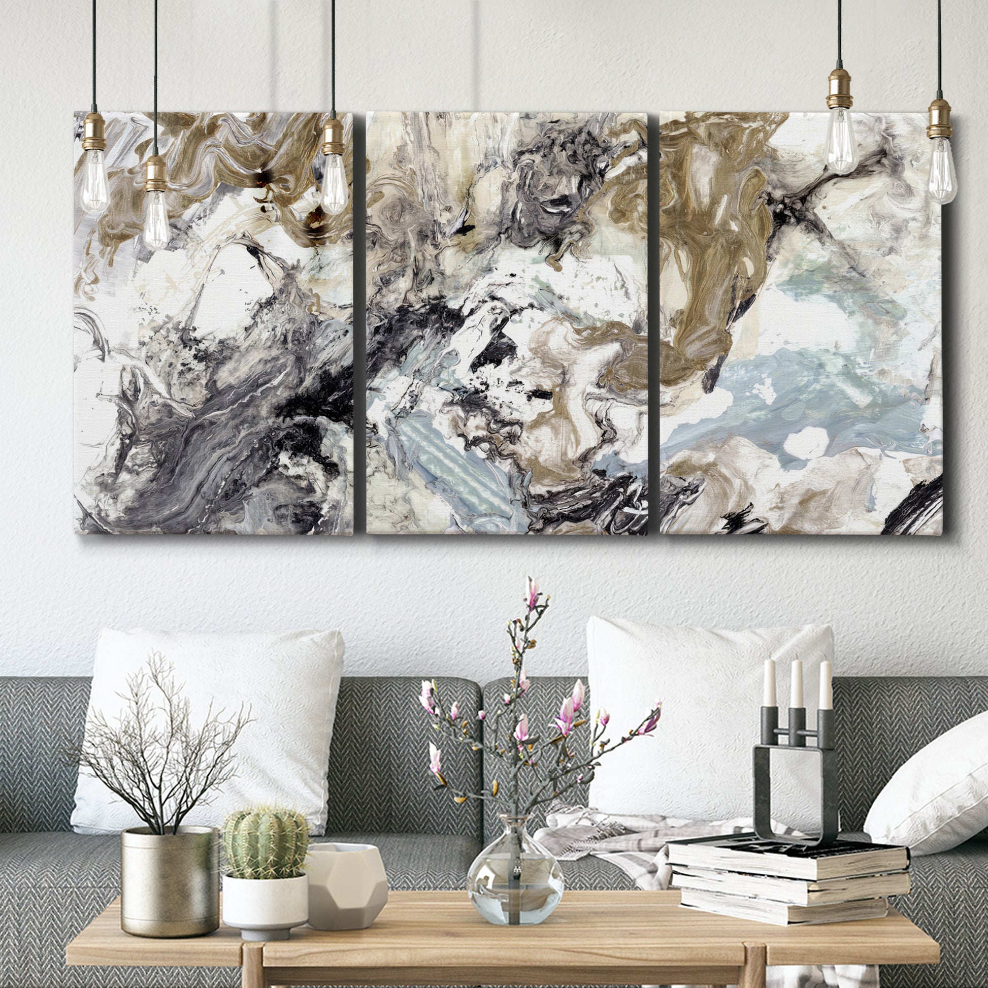Three-panel canvas wall art featuring marbled modern abstract textures, displayed in a modern living room above seating.