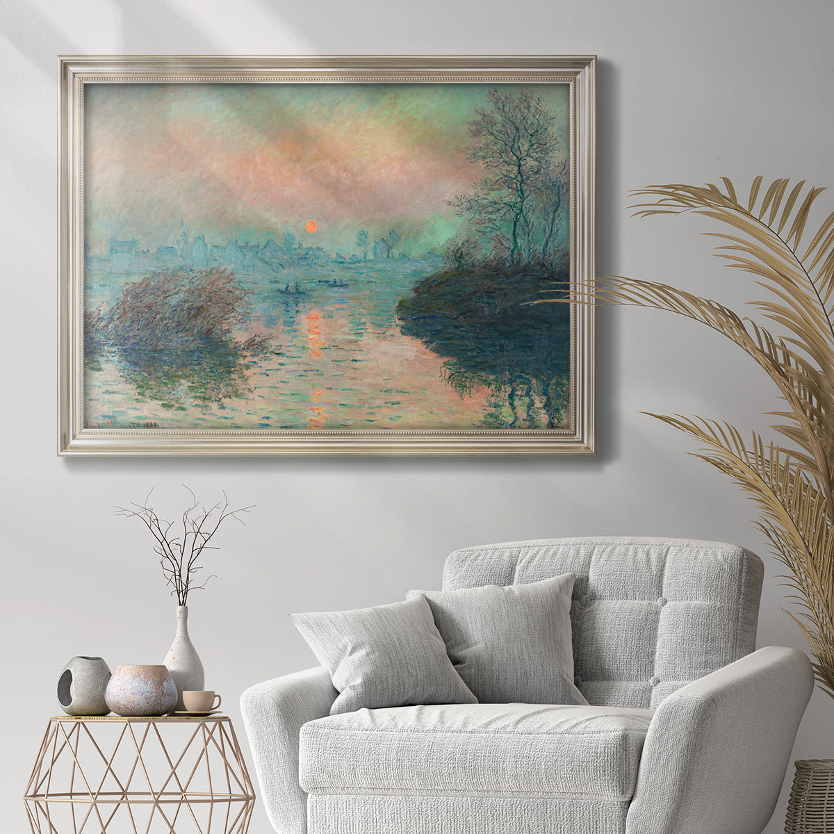 Impressionist winter river sunset scene by Claude Monet in an ornate champagne frame displayed in a bright interior setting.