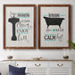 Set of two maple barnwood framed canvas prints depicting a coordinated art pair of playful bathtub silhouettes and bath-themed typography rendered as graphic bathroom word art above a dining room sideboard.