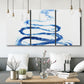 Three-panel canvas wall art featuring indigo abstract vapor watercolor, displayed in a modern living room above seating.