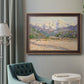 Impressionist valley landscape in southern France by Claude Monet in an ornate bronzed mahogany wood frame displayed in a bright interior setting.