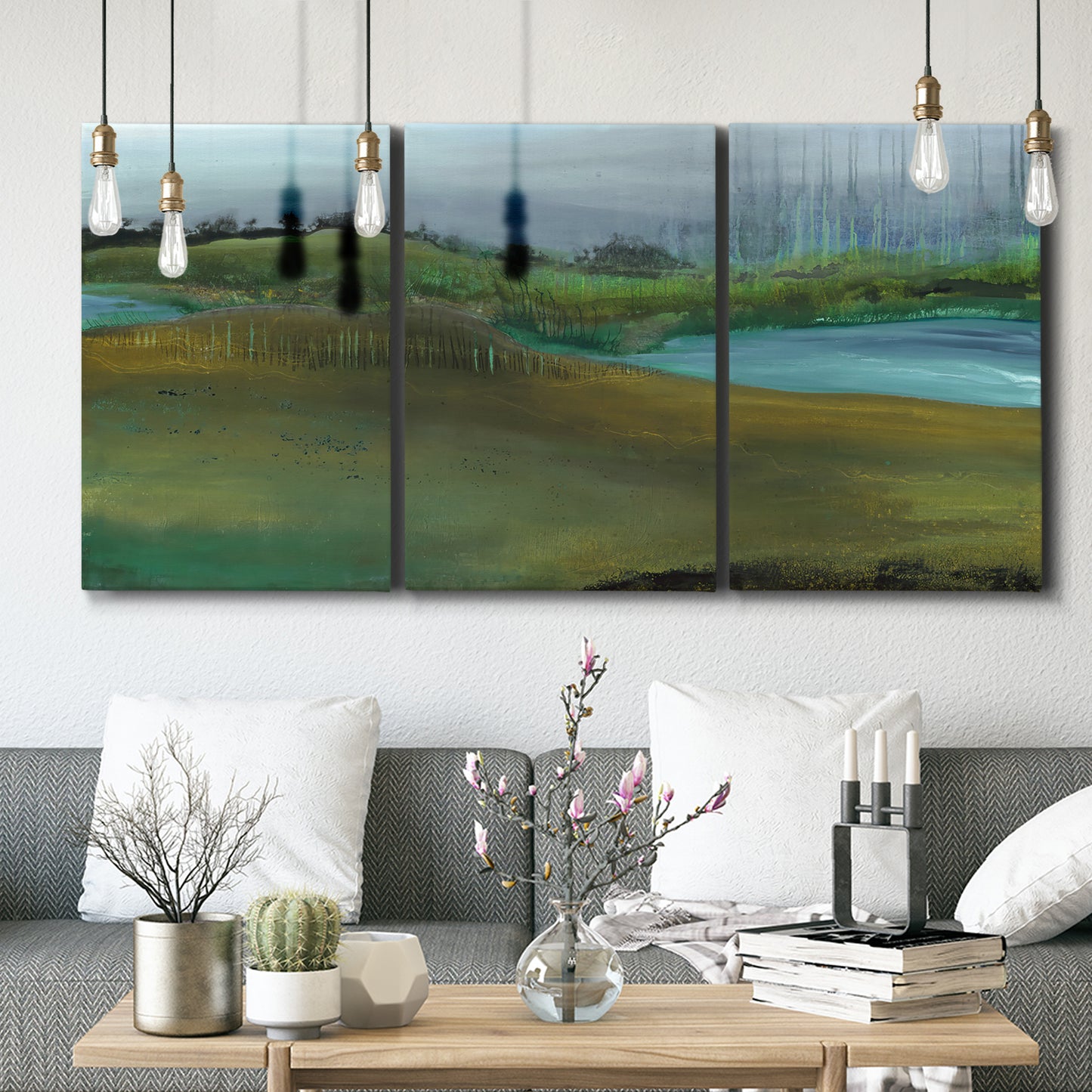 Three-panel canvas wall art featuring quiet contemplative landscape scene, displayed in a modern living room above seating.