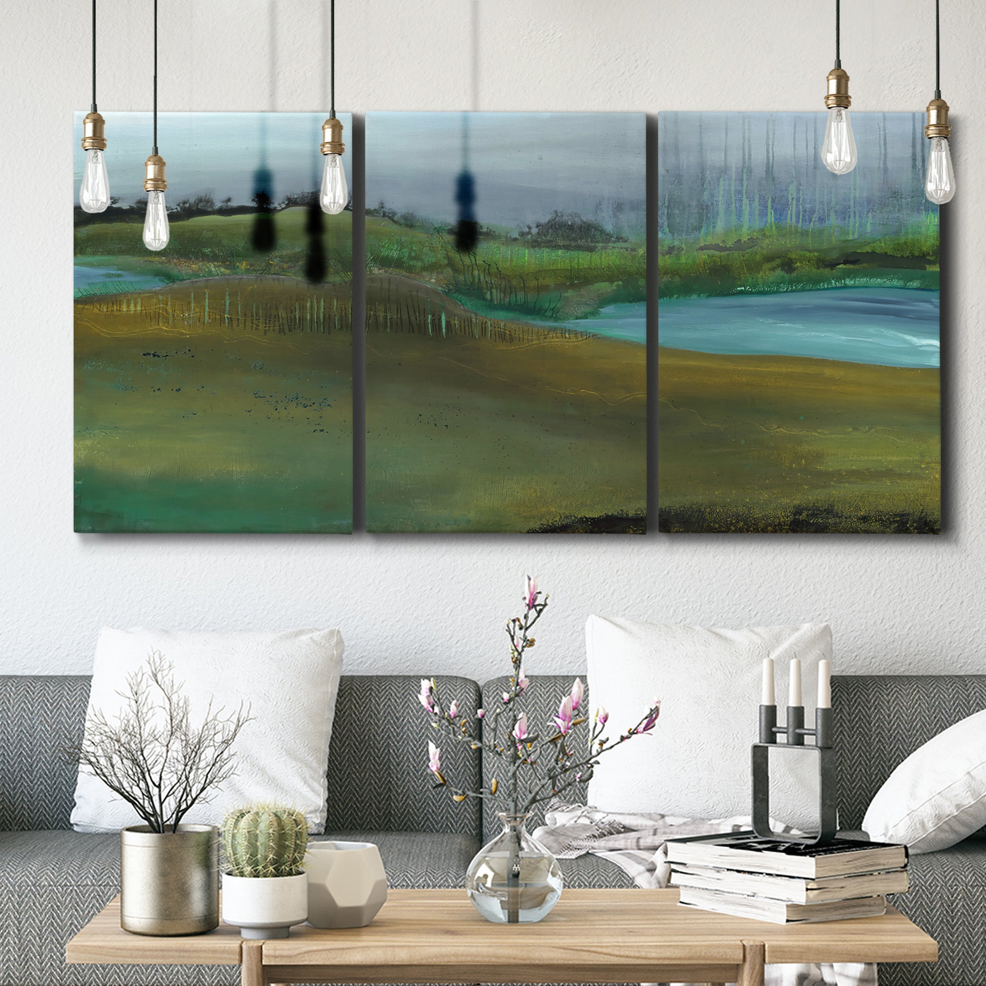 Three-panel canvas wall art featuring quiet contemplative landscape scene, displayed in a modern living room above seating.