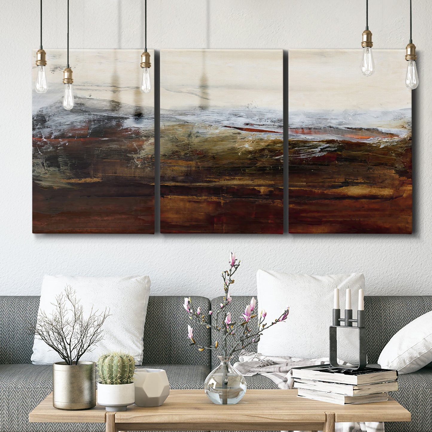 Three-panel canvas wall art featuring rustic abstract landscape exploration, displayed in a modern living room above seating.