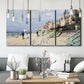 Three-panel canvas wall art featuring figures strolling along beach, displayed in a modern living room above seating.