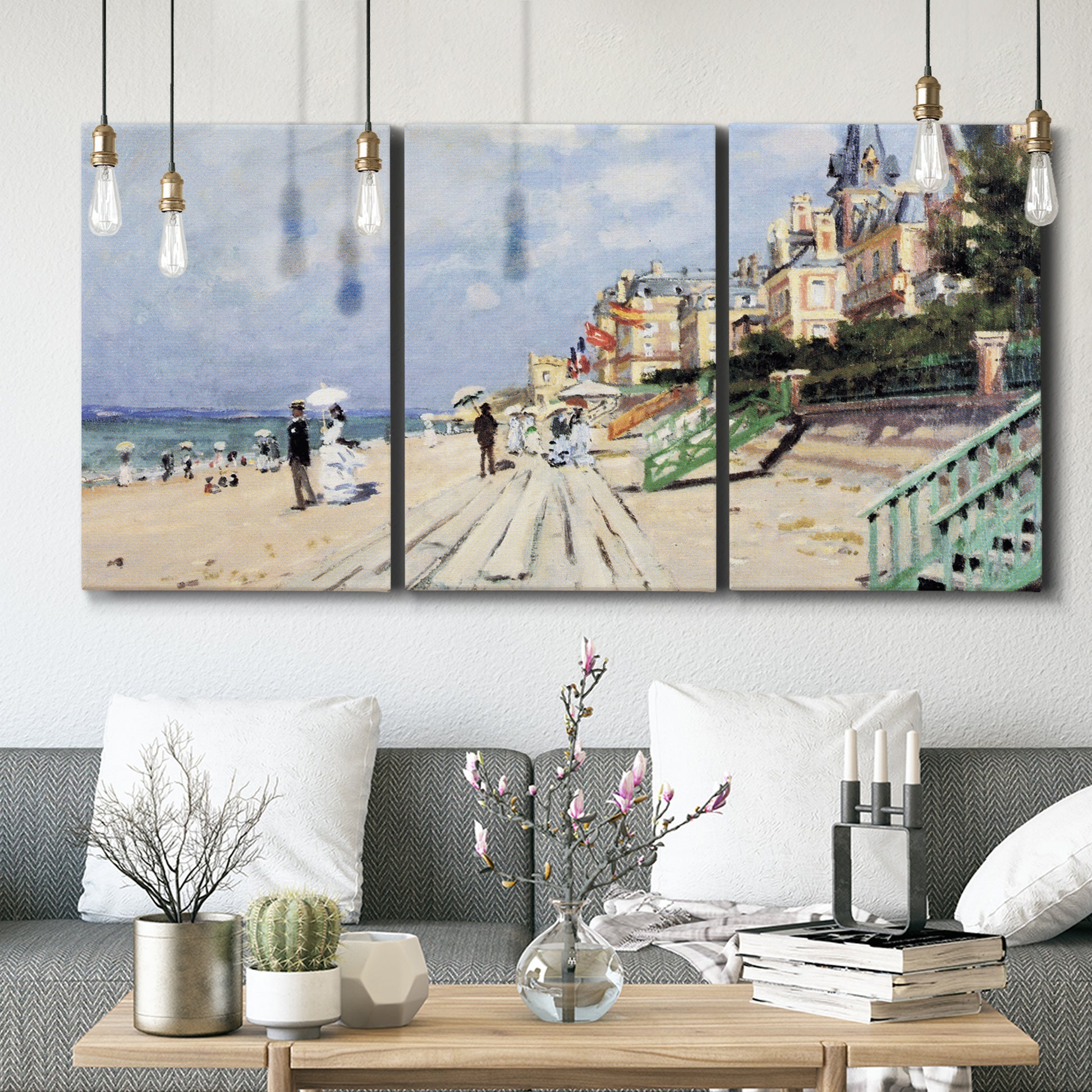 Three-panel canvas wall art featuring figures strolling along beach, displayed in a modern living room above seating.
