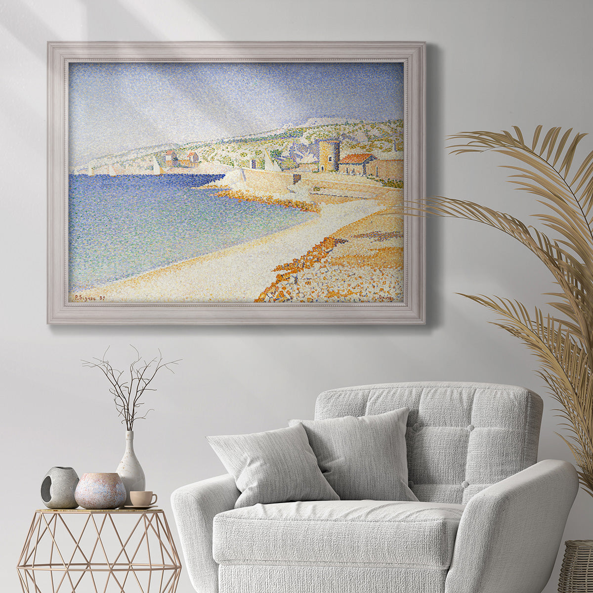 Impressionist Mediterranean jetty seascape by Paul Signac in an ornate weathered white frame displayed in a bright interior setting.