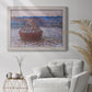 Impressionist single haystack landscape by Claude Monet in an ornate weathered white frame displayed in a bright interior setting.