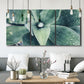 Three-panel canvas wall art featuring green succulent plant photograph, displayed in a modern living room above seating.
