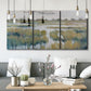 Three-panel canvas wall art featuring pastoral marshland landscape, displayed in a modern living room above seating.