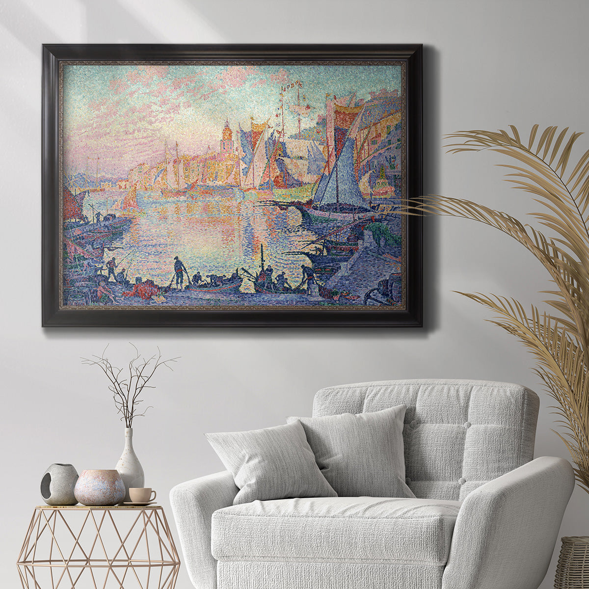 Impressionist Mediterranean harbor painting by Paul Signac in an ornate black frame with gilded inner detail displayed in a bright interior setting.