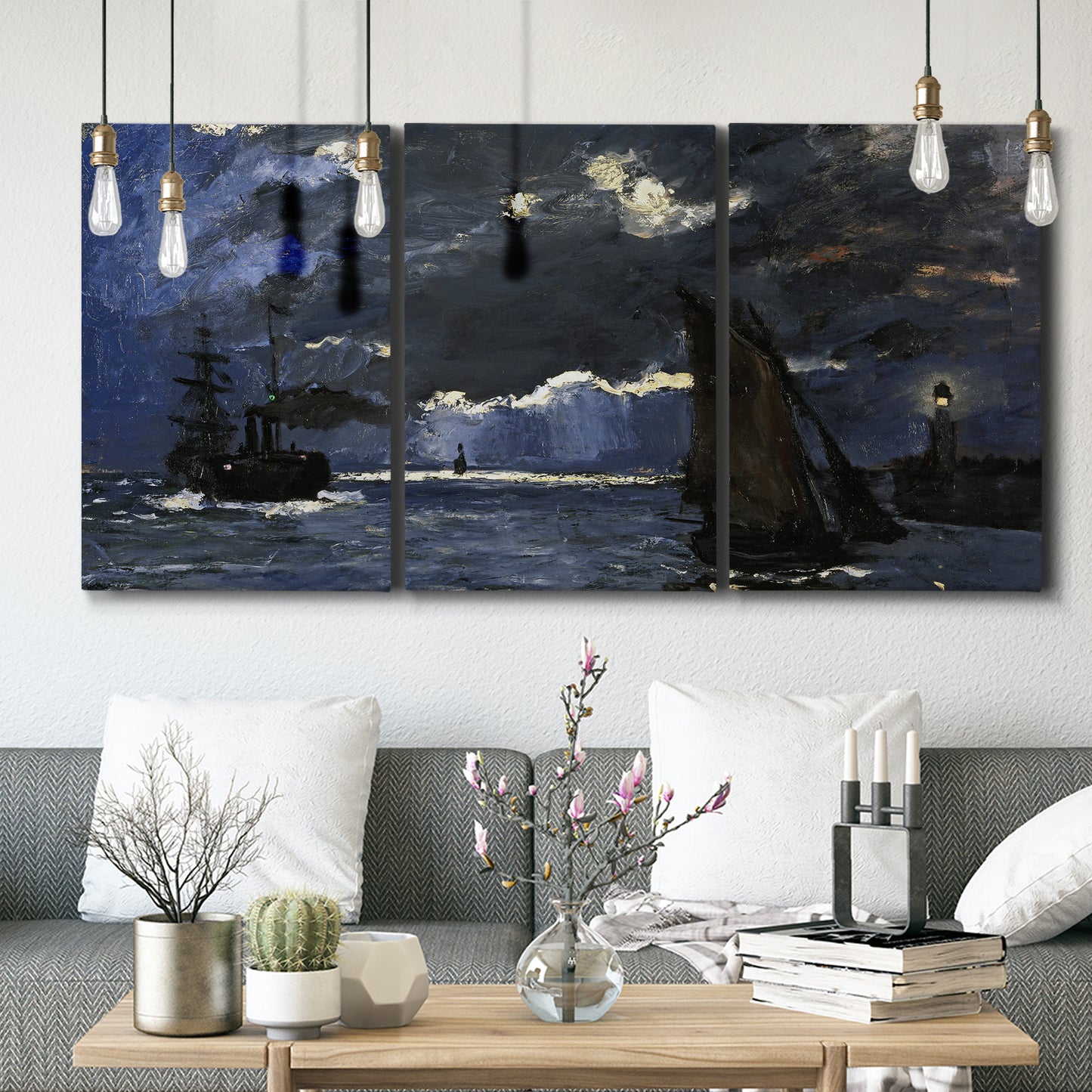 Three-panel canvas wall art featuring dark seascape under night sky, displayed in a modern living room above seating.