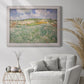 Impressionist countryside landscape near Auvers by Vincent van Gogh in an ornate weathered white frame displayed in a bright interior setting.