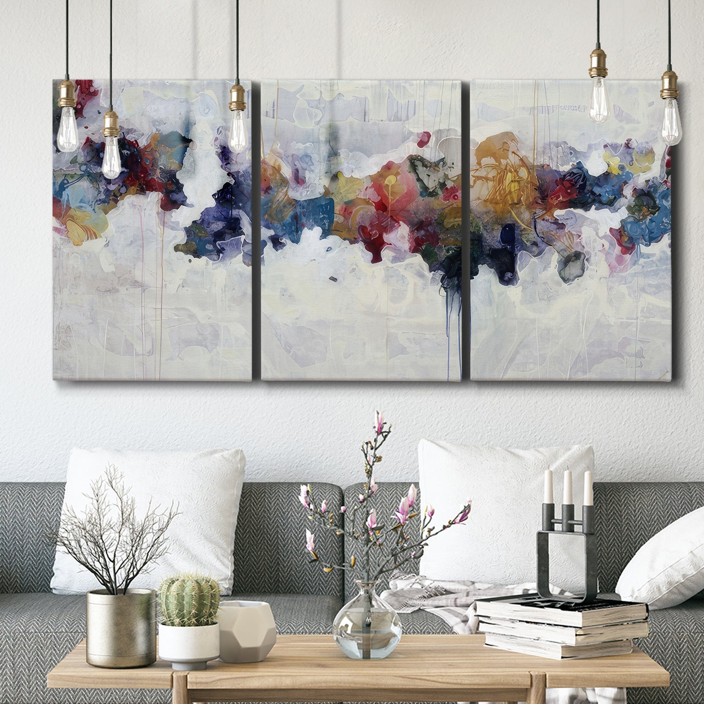 Three-panel canvas wall art featuring abstract water inspired composition, displayed in a modern living room above seating.