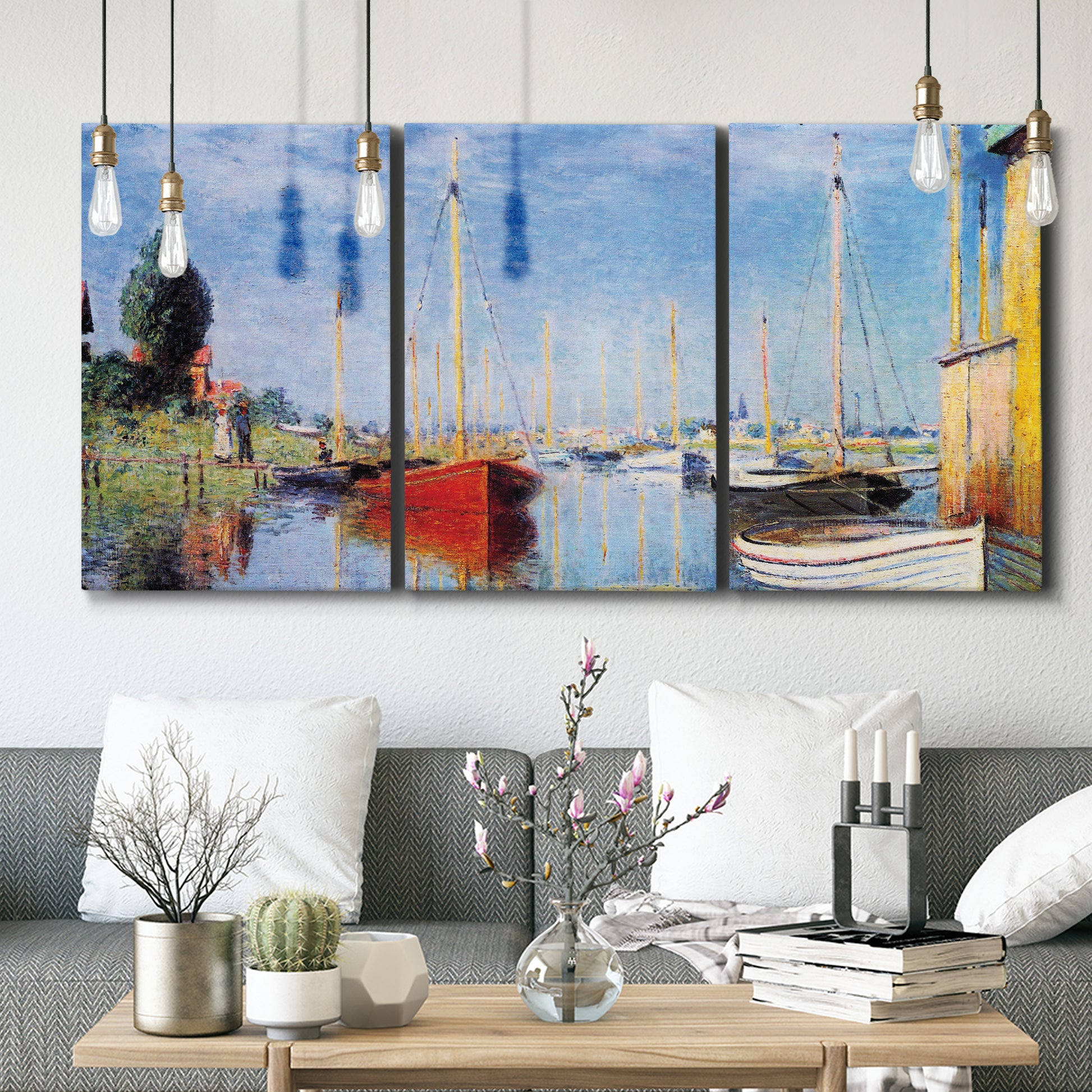 Three-panel canvas wall art featuring sailboats gathered along river, displayed in a modern living room above seating.