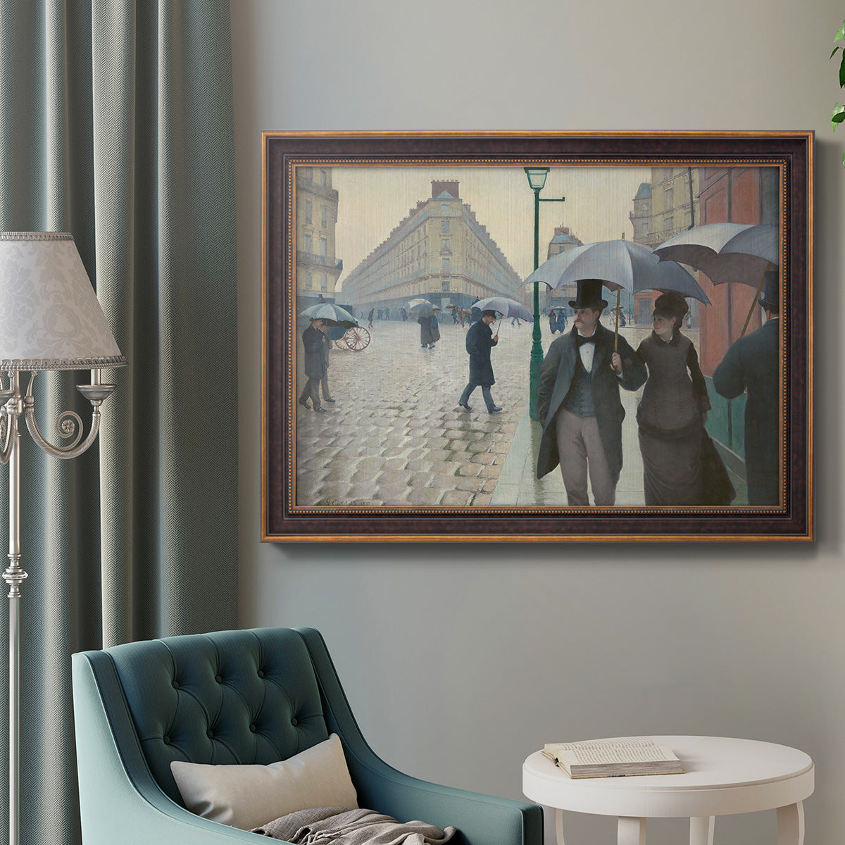 Impressionist urban street scene in the rain by Gustave Caillebotte in an ornate bronzed mahogany wood frame displayed in a bright interior setting.