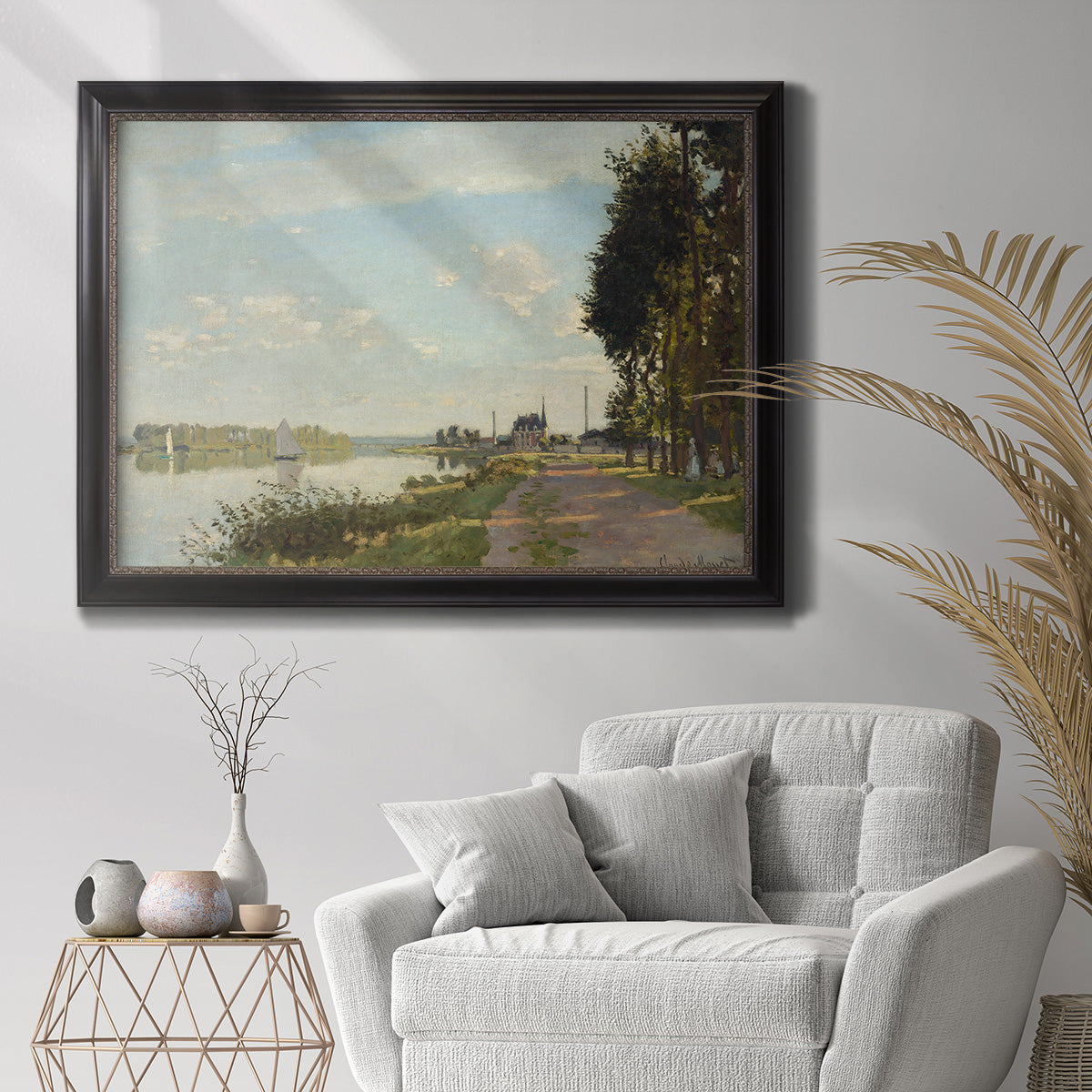 Impressionist river scene with red boats by Claude Monet in an ornate black frame with gilded inner detail displayed in a bright interior setting.