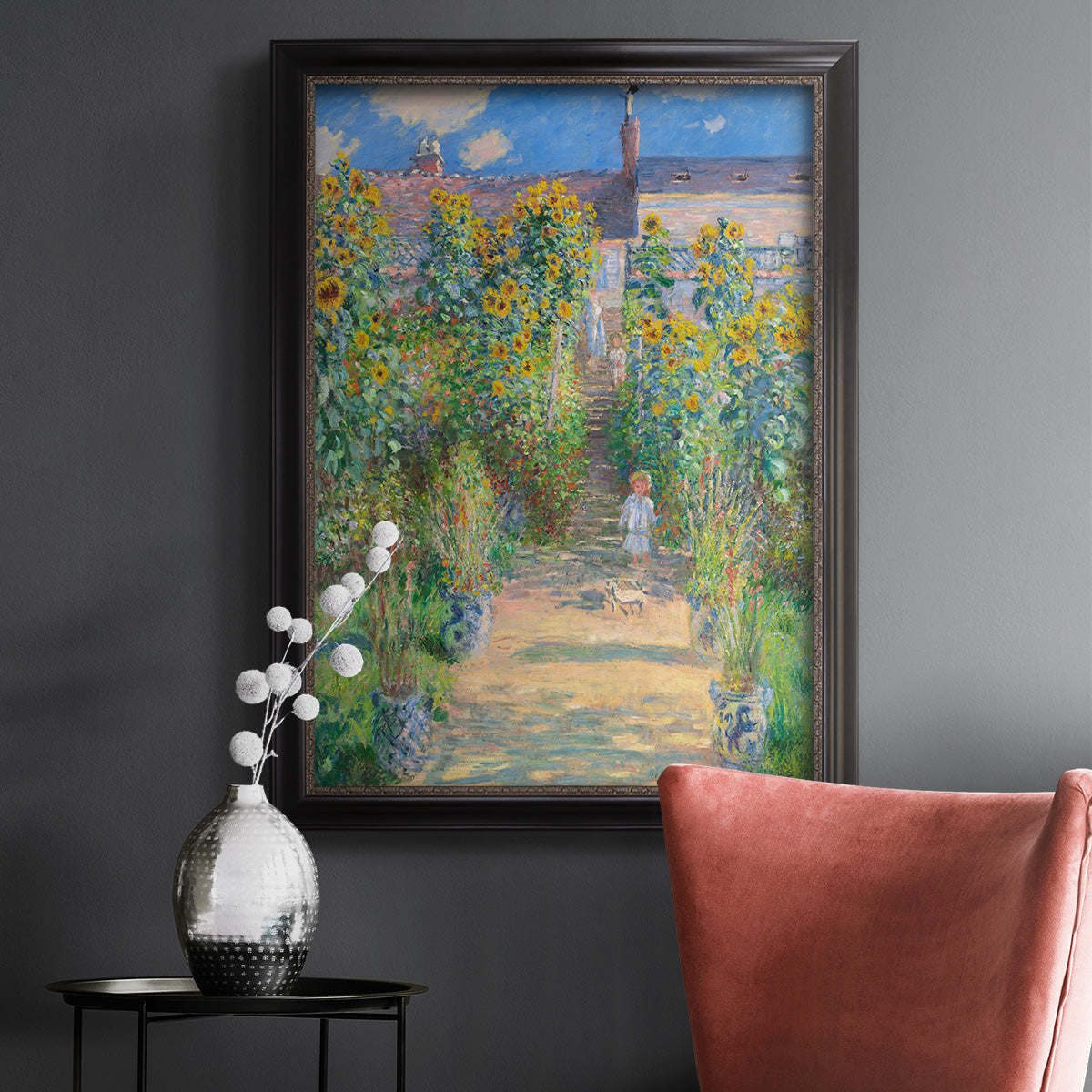 Impressionist garden landscape painting by Claude Monet in an ornate black frame with gilded inner detail displayed in a dark-toned interior setting.