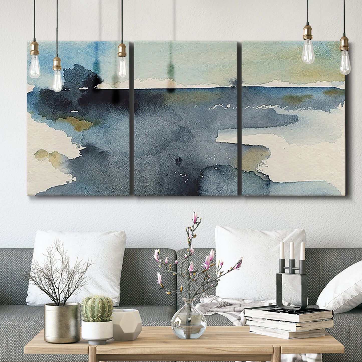 Three-panel canvas wall art featuring abstract watercolor with upward motion, displayed in a modern living room above seating.